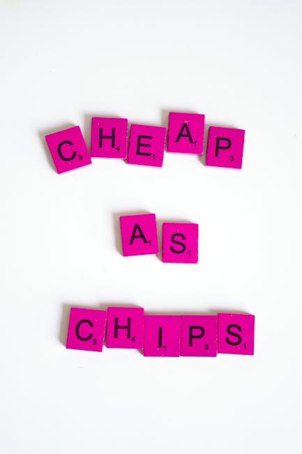 The image displays the words 'CHEAP', 'ASS', and 'CHIPS' spelled out with pink Scrabble tiles on a white background. The tiles are arranged in three horizontal rows, with 'CHEAP' at the top, 'ASS' in 